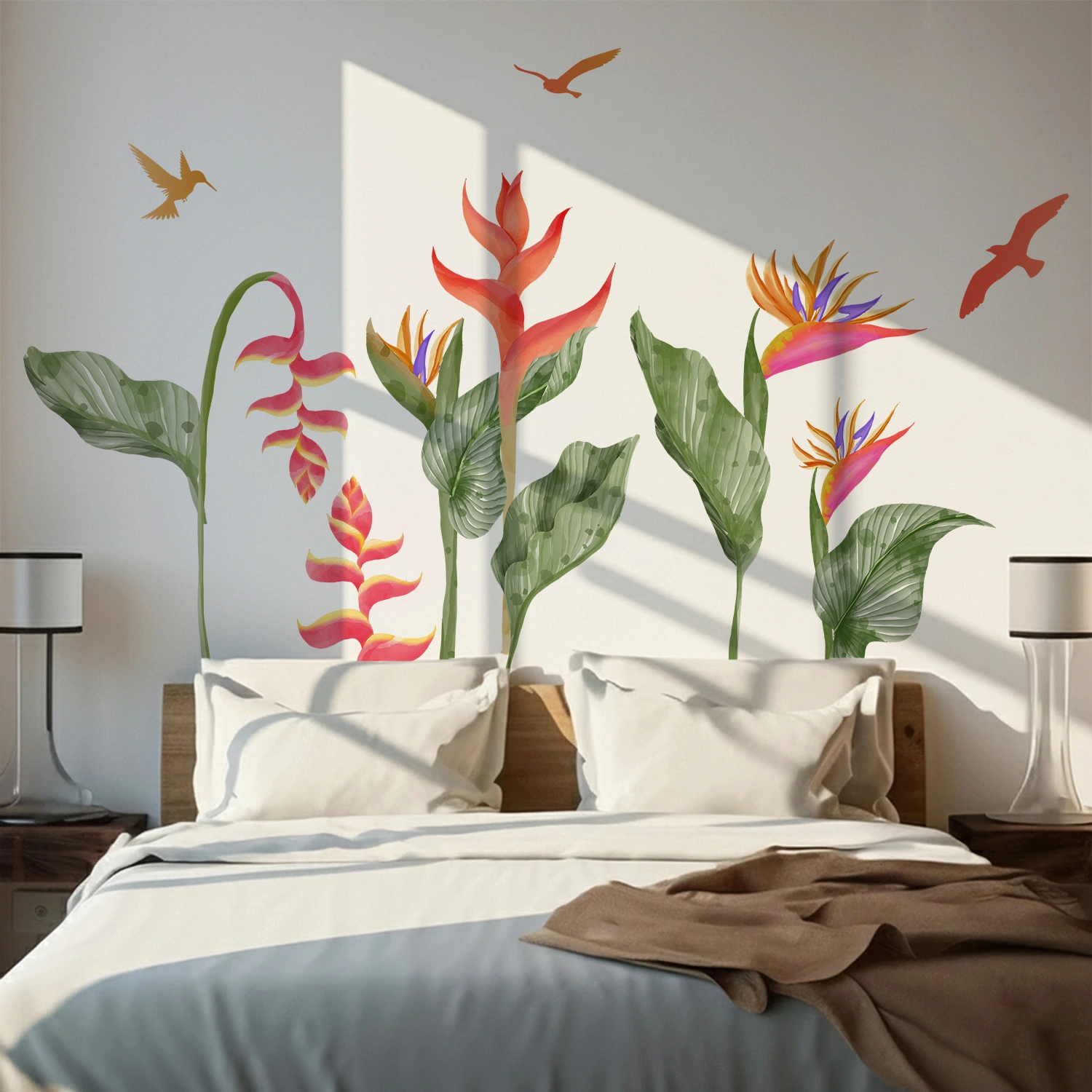 Colorful tropical heliconia and bird of paradise wall sticker with green leaves and flying birds above a bed on a white wall.