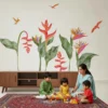 “Colorful tropical heliconia and bird of paradise wall sticker with green leaves and flying birds above a bed on a white wall.