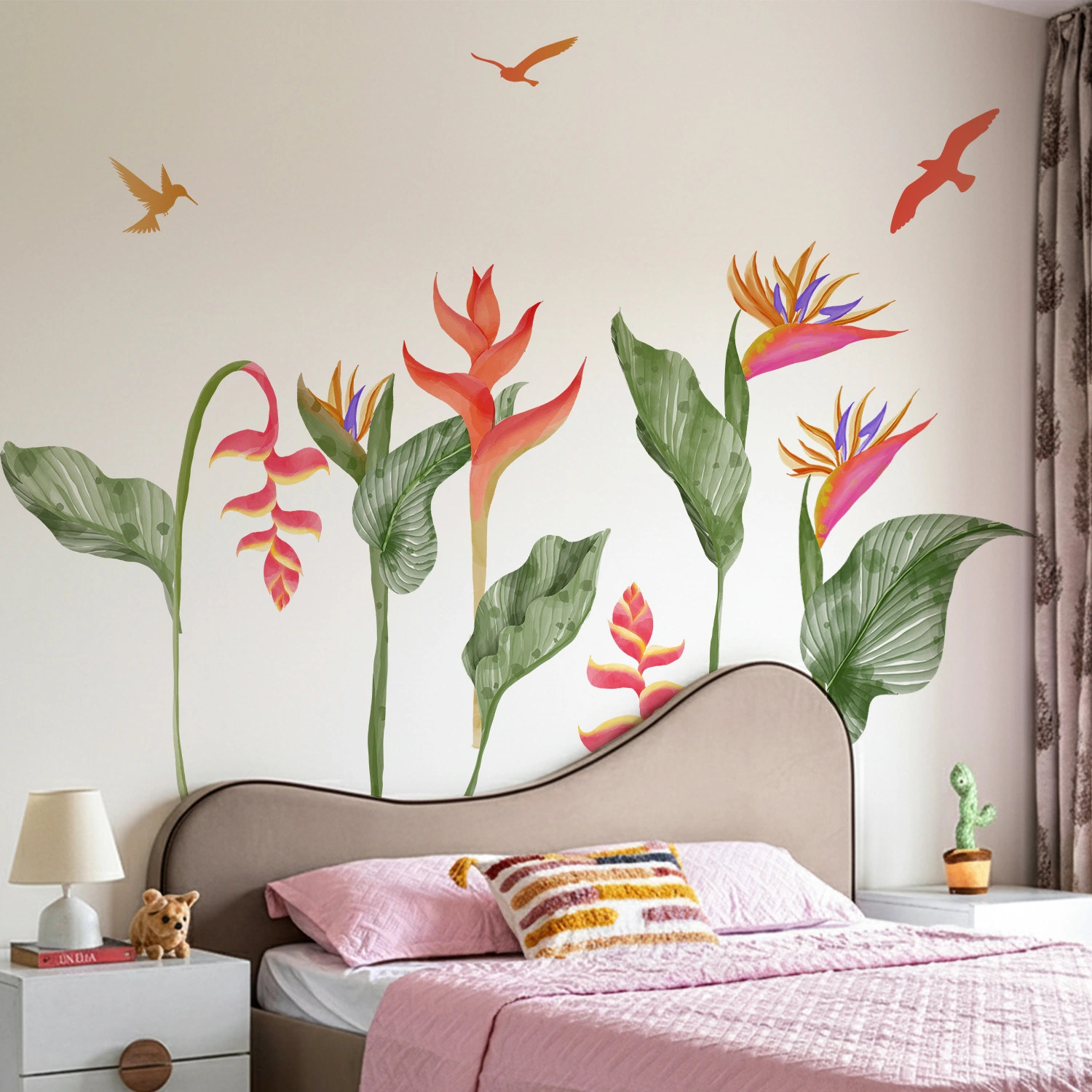 Colorful tropical heliconia and bird of paradise wall sticker with green leaves and flying birds above a bed on a white wall.