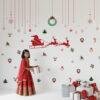 Christmas wall stickers featuring Santa sleigh, reindeer, wreaths, snowflakes, and festive hanging ornaments on a kids room wall