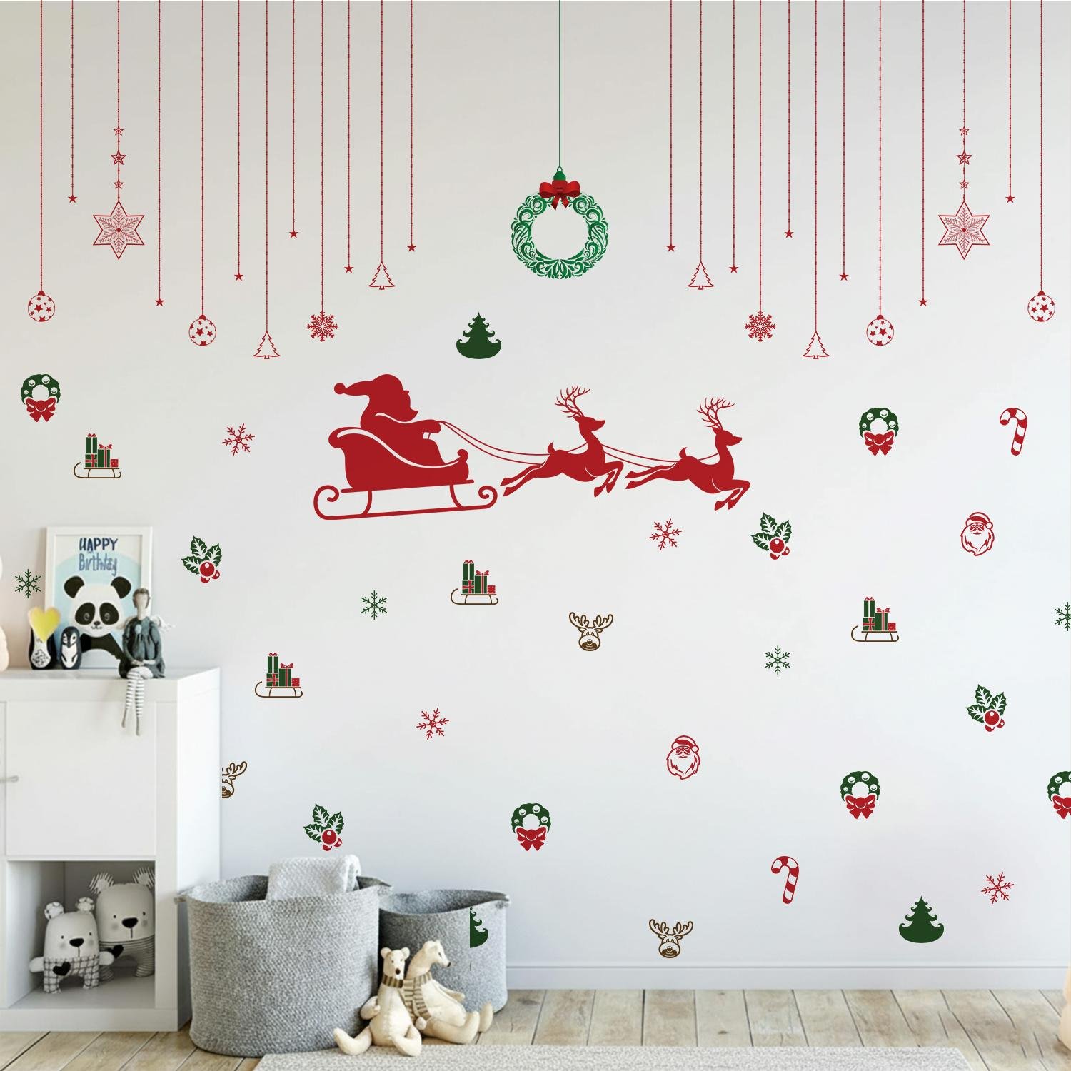 Christmas wall stickers featuring Santa sleigh, reindeer, wreaths, snowflakes, and festive hanging ornaments on a kids room wall