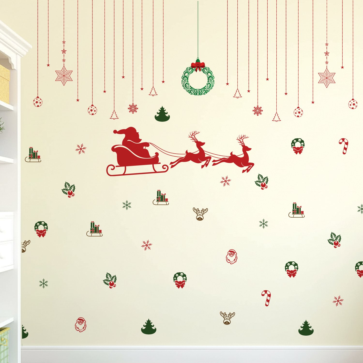 Christmas wall stickers featuring Santa sleigh, reindeer, wreaths, snowflakes, and festive hanging ornaments on a kids room wall
