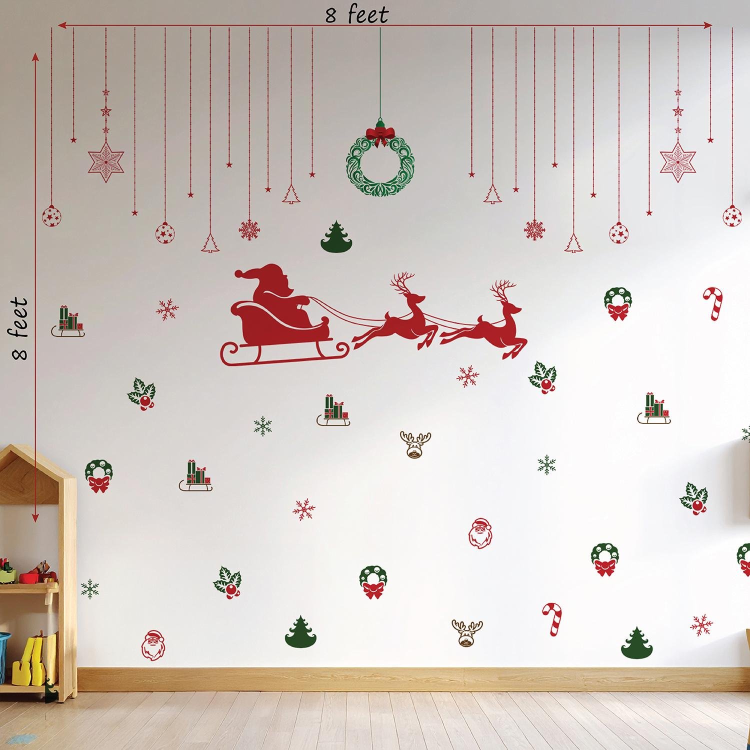 Christmas wall stickers featuring Santa sleigh, reindeer, wreaths, snowflakes, and festive hanging ornaments on a kids room wall