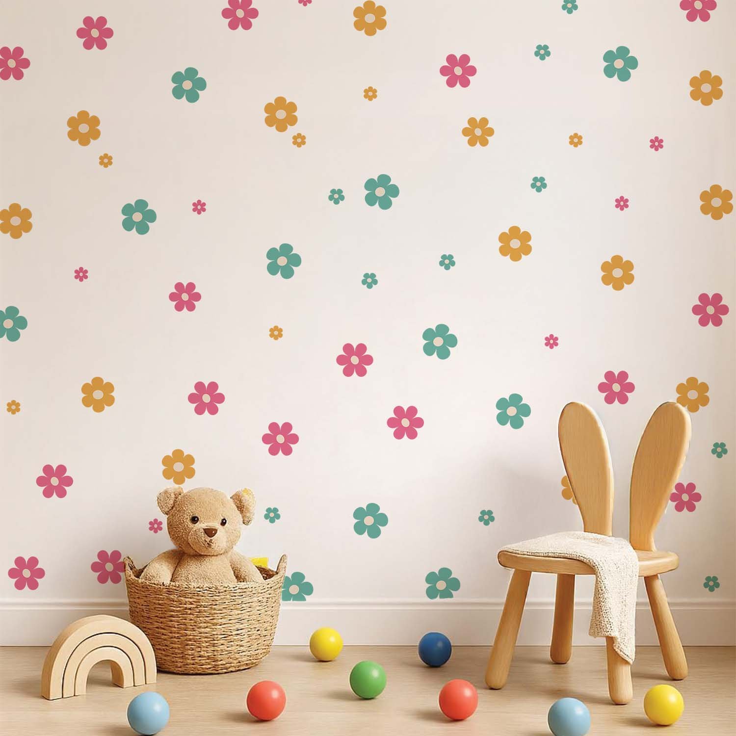 A nursery featuring pastel pink, blue, and lavender daisy wall stickers scattered across a white wall above a baby crib with plush toys.