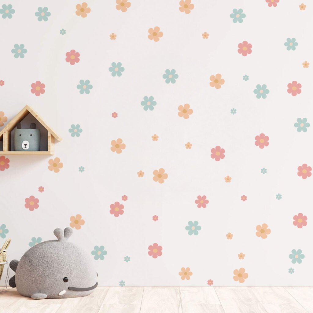 A nursery featuring pastel pink, blue, and lavender daisy wall stickers scattered across a white wall above a baby crib with plush toys.