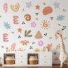 Boho abstract wall stickers for kids room featuring pastel flowers, leaves, stars, sunshine, and geometric shapes on a white nursery wall with removable peel-and-stick vinyl decals.