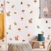 Watercolor woodland animal wall stickers featuring baby deer, rabbits, birds, mushrooms, acorns, oak leaves, and forest elements on a nursery wall with removable peel-and-stick vinyl decals.