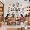 Coffee wall sticker featuring Must Have Coffee typography, espresso cups, latte illustrations, and coffee-themed icons on a kitchen wall.